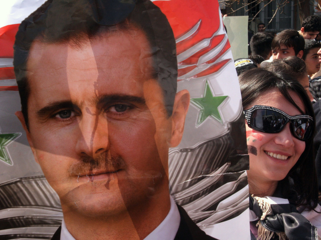 A supporter of Syrian President Bashar Assad carried a poster with his image in Damascus earlier today (March 29, 2011).