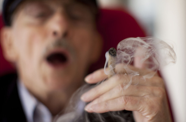 Moshe Rute smokes marijuana at the Hadarim nursing home in Kibutz Naan, Israel, in early March. The Israeli government and a private company are distributing cannabis for medicinal purposes to more than 1,800 people in Israel.