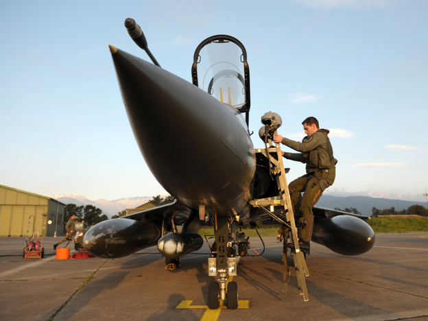 A French pilot gets into the cockpit of a Mirage 2000 jet at the Solenzara base.