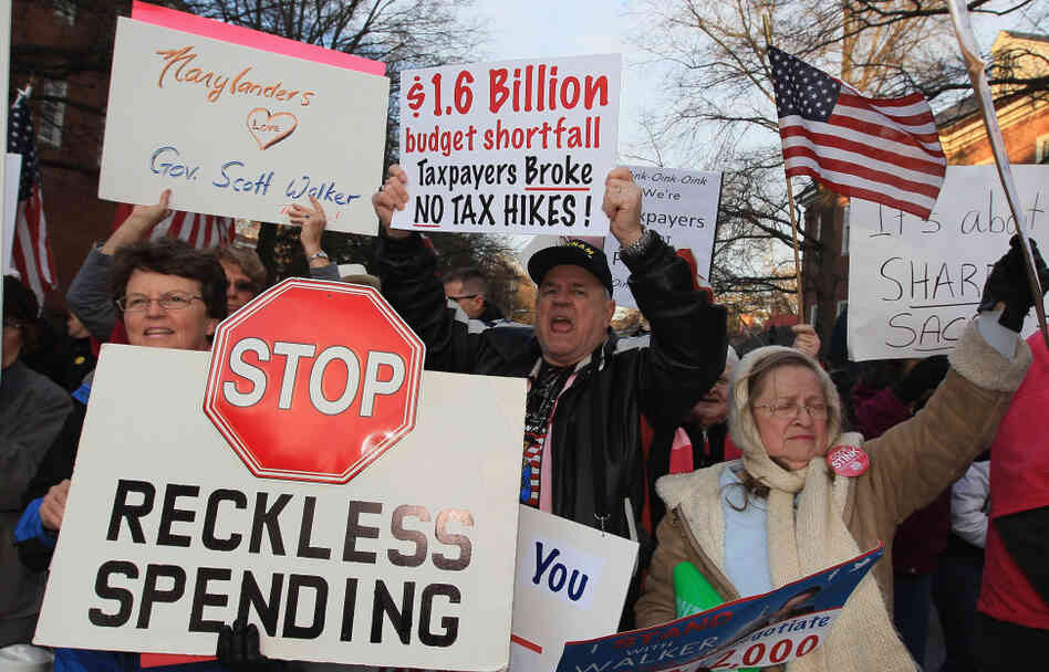 Tea Party supporters hold signs across from a rally held by the American Federation of State, County and Municipal Employees in front of the Maryland State Capitol building in Annapolis on March 14.