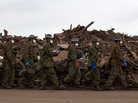 Japanese Self-Defense Force soldiers walked in a line after finding the body of a boy in the rubble in Higashimatsushima, Miyagi prefecture earlier today (March 31, 2011).