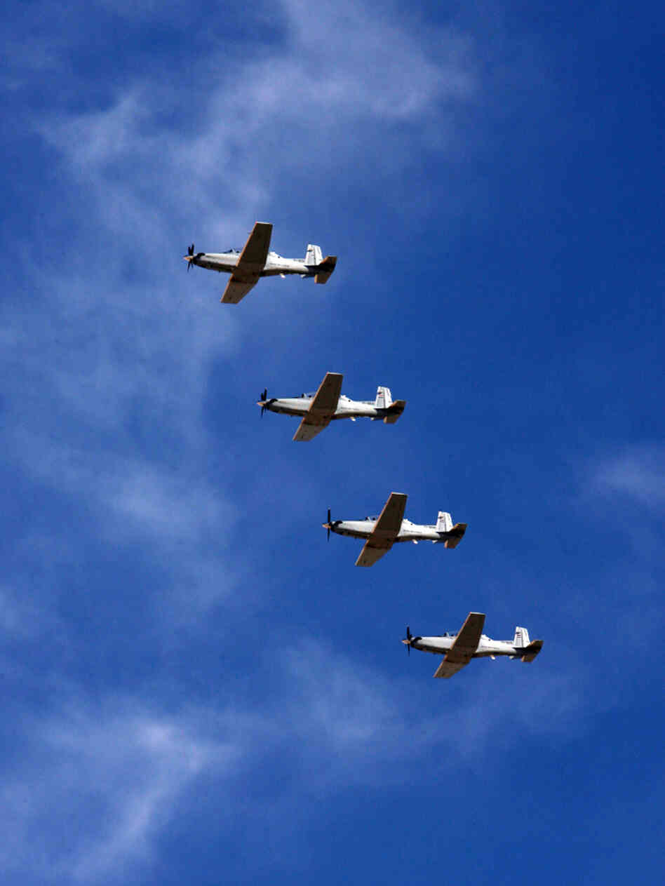 T-6 planes for pilot training fly over the Iraqi Air Force academy during its reopening ceremony north of Tikrit in December 2009.
