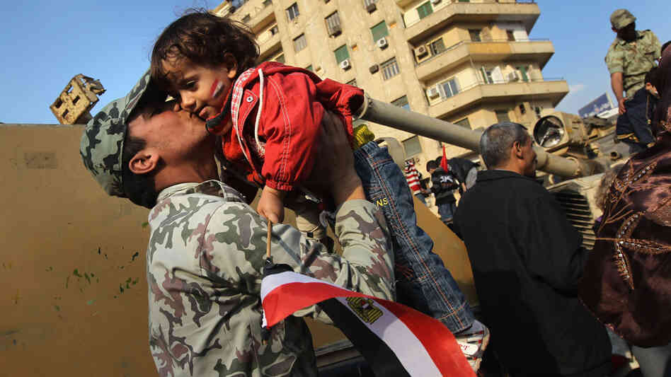 An Egyptian army soldier kisses a child in Tahrir Square in Cairo on Feb. 12, the day after President Hosni Mubarak resigned. An Egyptian army soldier kisses a child in Tahrir Square in Cairo on Feb. 12, the day after President Hosni Mubarak resigned.