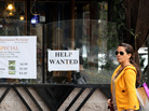 A woman walks by a "Help Wanted" sign taped to the window of a restaurant in San Francisco. Some employers are refusing to consider hiring anyone who doesn't already have a job, leading to increased scrutiny by the EEOC. A woman walks by a "Help Wanted" sign taped to the window of a restaurant in San Francisco. Some employers are refusing to consider hiring anyone who doesn't already have a job, leading to increased scrutiny by the EEOC.