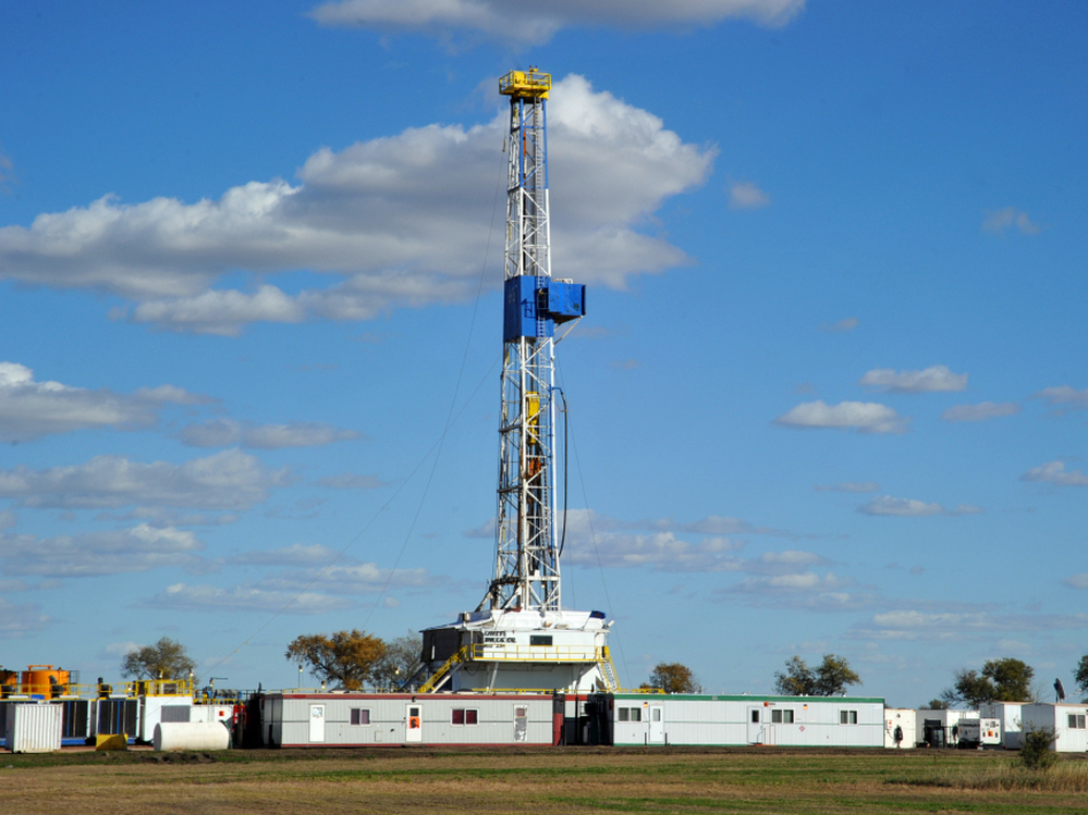 An oil drilling rig is seen near Ray, N.D., last September. The well is being drilled into the Bakken Formation, one of the largest contiguous deposits of oil and natural gas in the United States.