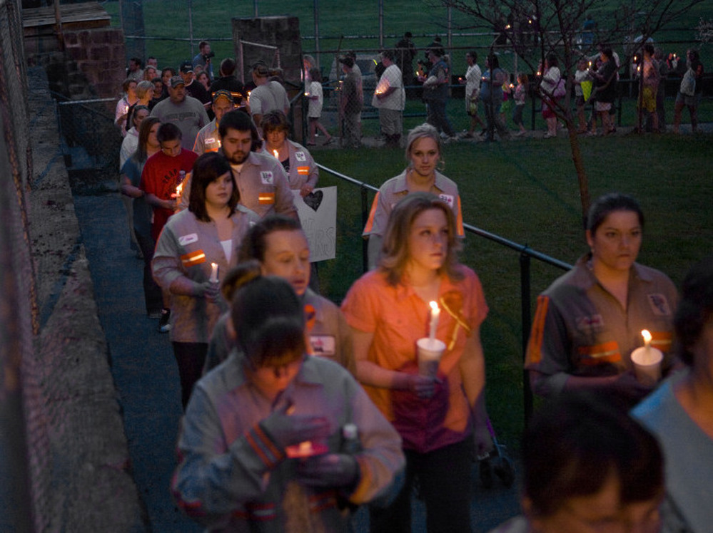 Community members, friends and family participate in a vigil held for the victims of the Upper Big Branch mine in front of the Whitesville Elementary School on April 7, 2010.