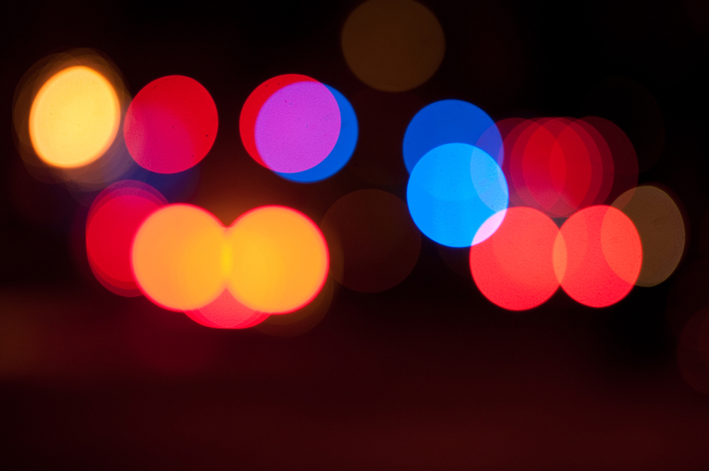 Blurred police and ambulance sirens at night.