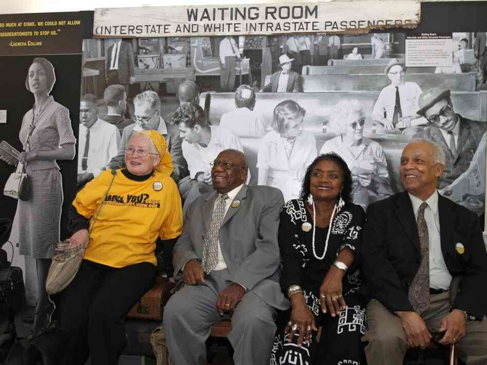 From left to right, Freedom Riders Joan Mulholland, Charles Person, Catherine Burks-Brooks and Reginald Green pose in front of a student-created exhibit on display at the University of Mary Washington in Fredericksburg, Va.