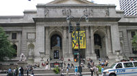 Pedestrians walk past the main building of the New York Public Library. But will they be going in to check out books in the future?