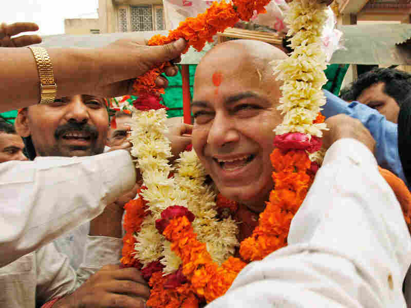 Bhratiya Janata Party leader Vijay Jolly is garlanded as he comes out of Lord Hanuman or the monkey god's temple after taking his blessings for contesting in the state elections in New Delhi on Nov. 11, 2008. Bhratiya Janata Party leader Vijay Jolly is garlanded as he comes out of Lord Hanuman or the monkey god's temple after taking his blessings for contesting in the state elections in New Delhi on Nov. 11, 2008.