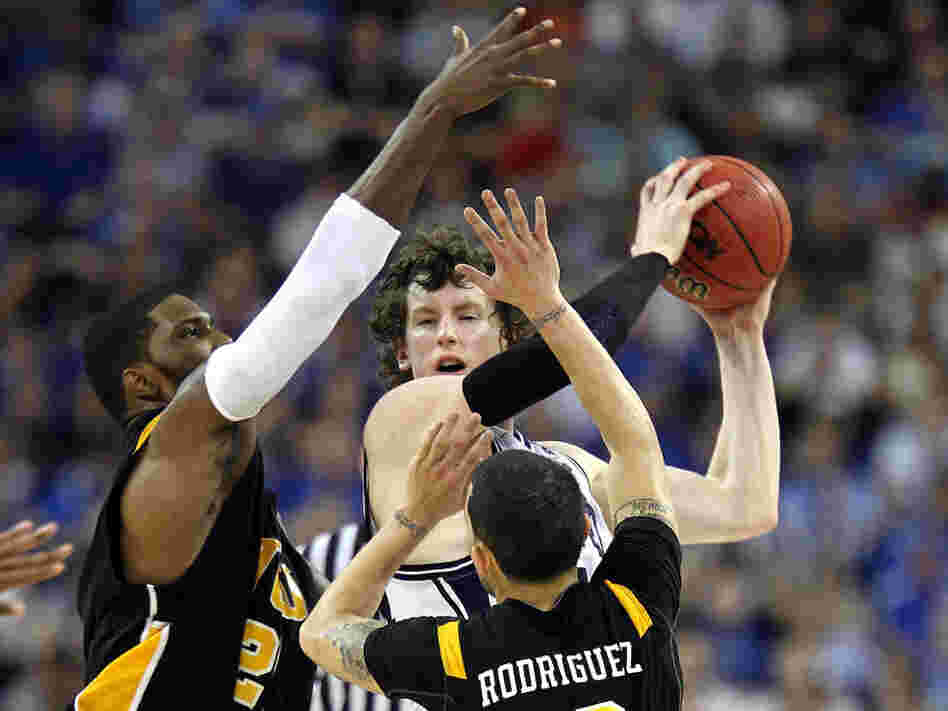 Matt Howard (center) of the Butler Bulldogs handles the ball against Jamie Skeen (left) and Joey Rodriguez of the Virginia Commonwealth Rams during the National Semifinal game of the 2011 NCAA Division I Men's Basketball Championship at Reliant Stadium on April 2 in Houston.
