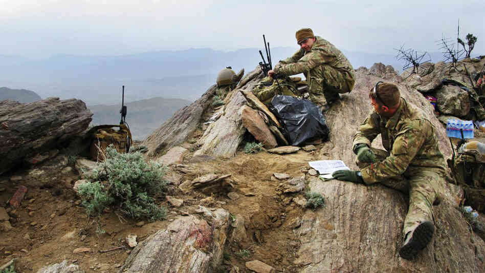 Lt. Col. Brian Filler (left) and Tech. Sgt. John Oliver watch over the Galuch Valley from the top of a mountain in Laghman province in eastern Afghanistan on March 27. They are part of a team of Joint Terminal Attack Controllers for the U.S. Air Force, traveling on the ground with combat troops and coordinating with aircraft to reduce the likelihood of airstrike errors. Lt. Col. Brian Filler (left) and Tech. Sgt. John Oliver watch over the Galuch Valley from the top of a mountain in Laghman province in eastern Afghanistan on March 27. They are part of a team of Joint Terminal Attack Controllers for the U.S. Air Force, traveling on the ground with combat troops and coordinating with aircraft to reduce the likelihood of airstrike errors.