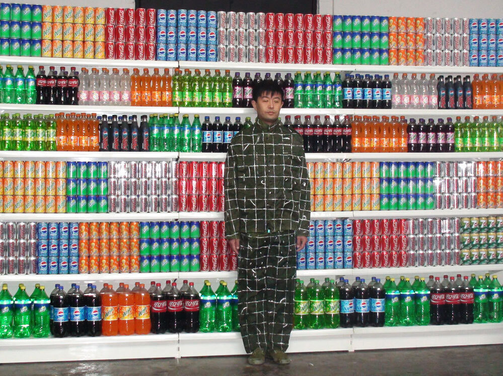 Liu Bolin prepares for his piece Supermarket No.2.