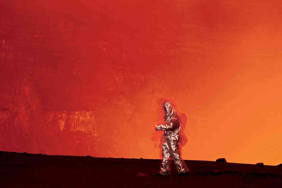 "Photographer Carsten Peter tests a thermal suit that is used to get close to the lava lake. For 30 years Peter has explored volcanoes around the world. 'Seeing at close range the primal forces that shaped the planet can be hypnotic. You cannot allow yourself to fall under a volcano's spell, especially one as unpredictable as Nyiragongo. That can be a fatal mistake.' "
