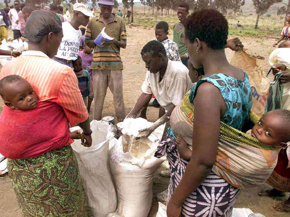 In this Aug. 27, 1998, photo, families from Rwanda await distribution of food at the Kingtele refugee camp near Brazzaville, Congo. At the time, the camp hosted more than 4,000 Hutu refugees who feared the arrival of Tutsi rebels on the other side of the Congo River. In this Aug. 27, 1998, photo, families from Rwanda await distribution of food at the Kingtele refugee camp near Brazzaville, Congo. At the time, the camp hosted more than 4,000 Hutu refugees who feared the arrival of Tutsi rebels on the other side of the Congo River.