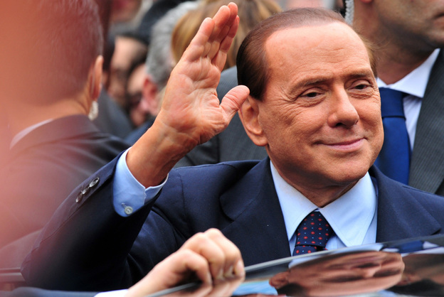 Italian Prime Minister Silvio Berlusconi acknowledges his supporters after a legal hearing on March 28.