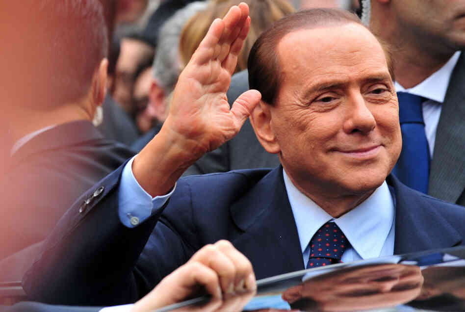Italian Prime Minister Silvio Berlusconi acknowledges his supporters after a legal hearing on March 28.