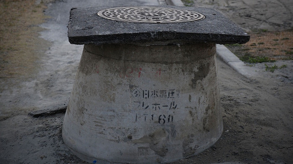 Manholes poke out from the ground in Urayasu, Japan, due to the liquefaction triggered by the 9.0 magnitude earthquake. The phenomenon, which allows sand and water to rise following ground shaking, was particularly pronounced in this area as a result of the long duration of the March 11 quake.