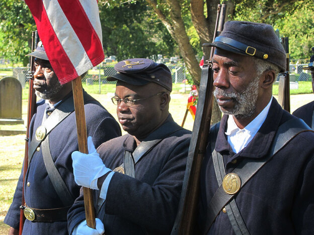 Civil War re-enactors representing the 54th  Massachusetts Volunteer Infantry dedicate a  gravestone for a black Civil War veteran in Charleston, S.C., in November 2010.