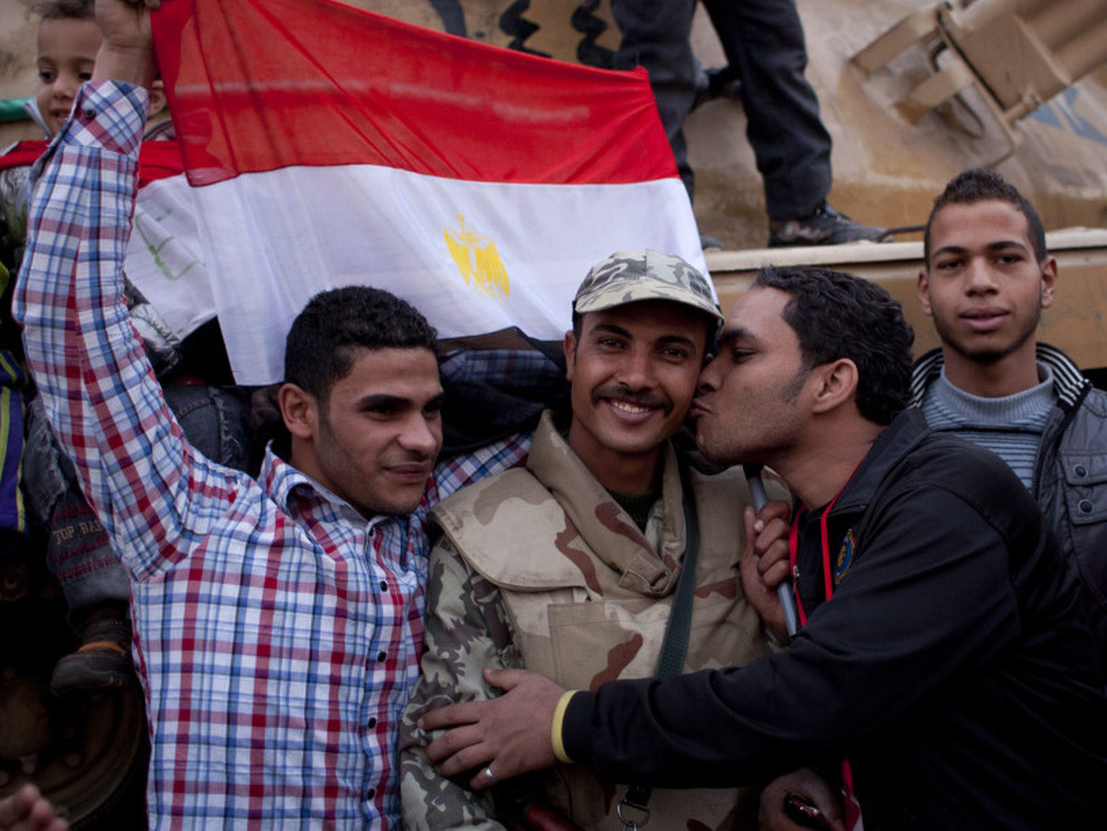 An anti-government protester kisses an army soldier during celebrations in Cairo's Tahrir Square on Feb. 12, after President Mubarak stepped down. Now, the revolution's leaders say the army is continuing the repressive practices of the former regime.