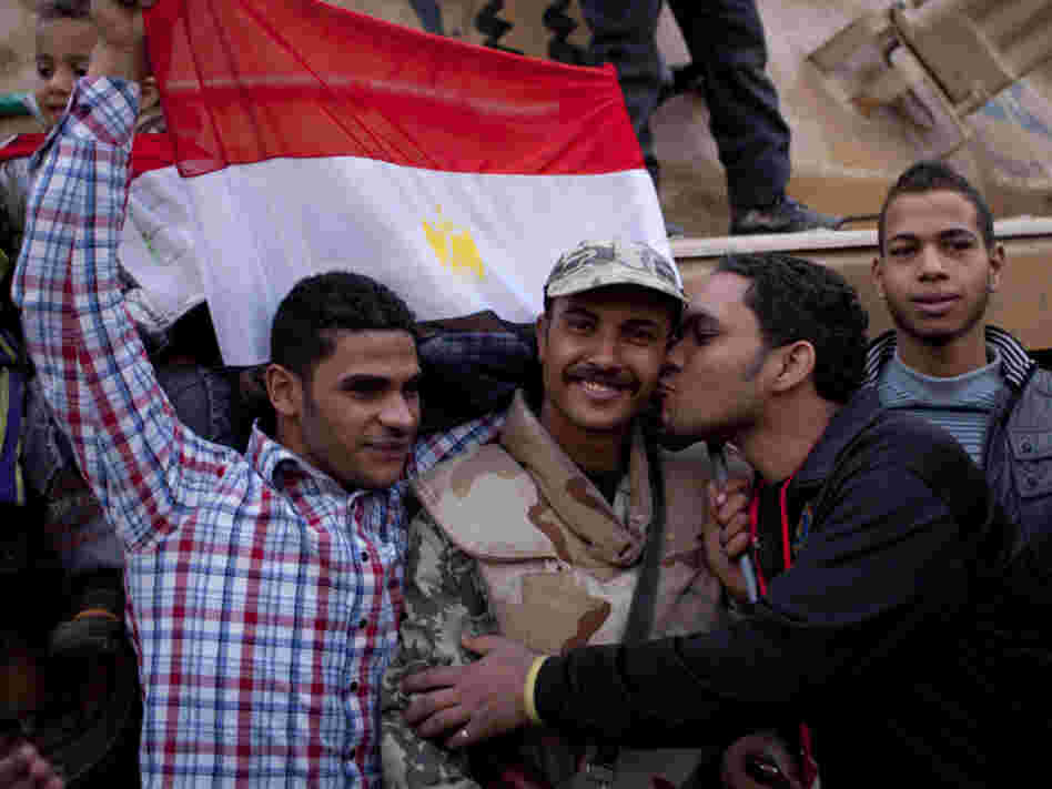 An anti-government protester kisses an army soldier during celebrations in Cairo's Tahrir Square on Feb. 12, after President Mubarak stepped down. Now, the revolution's leaders say the army is continuing the repressive practices of the former regime.
