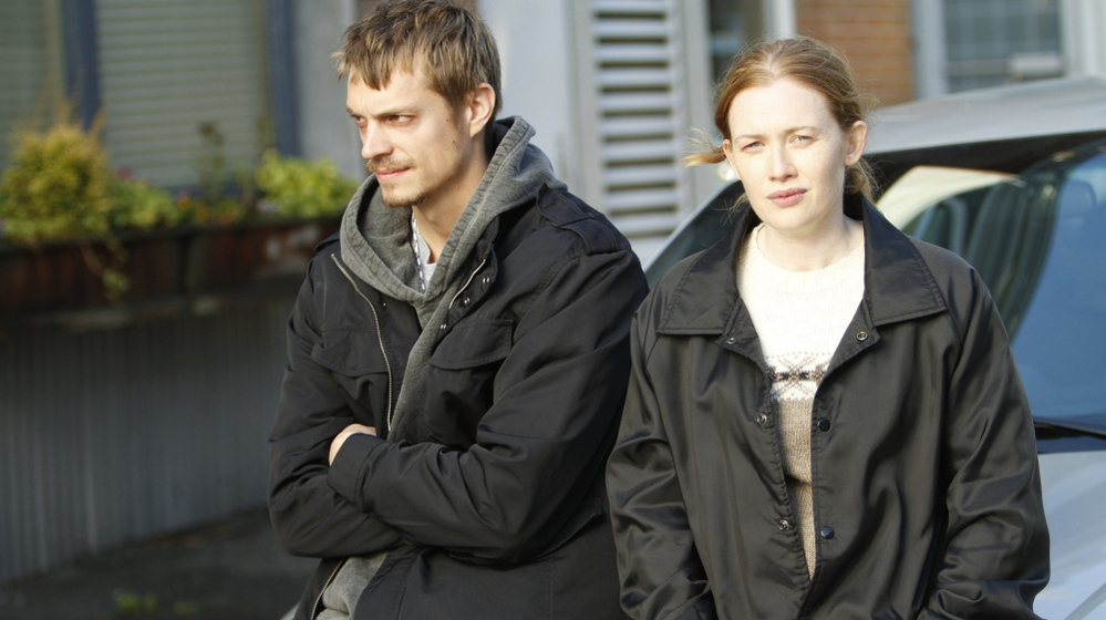 Detectives Stephen Holder (Joel Kinnaman) and Sarah Linden (Mireille Enos) are assigned to work together on AMC's latest drama series, The Killing.