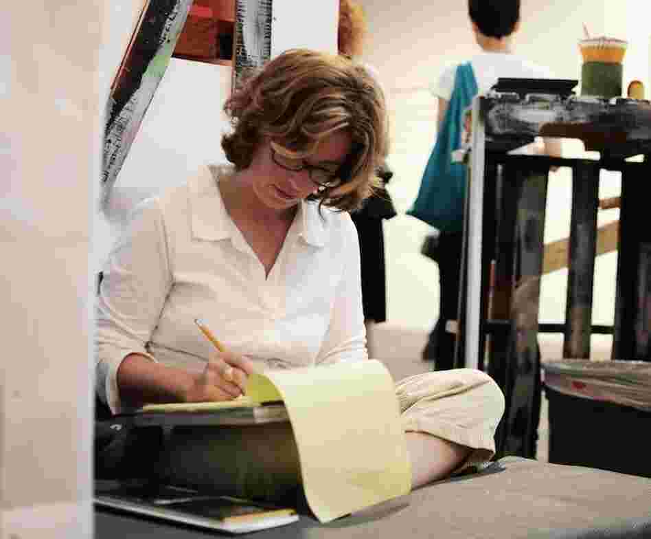 Writer Gaby Calvocoressi pens an impromptu poem at Abe's Penny Live, an O, Miami event in which visitors were invited to write poetry in response to the work of Miami photographers.