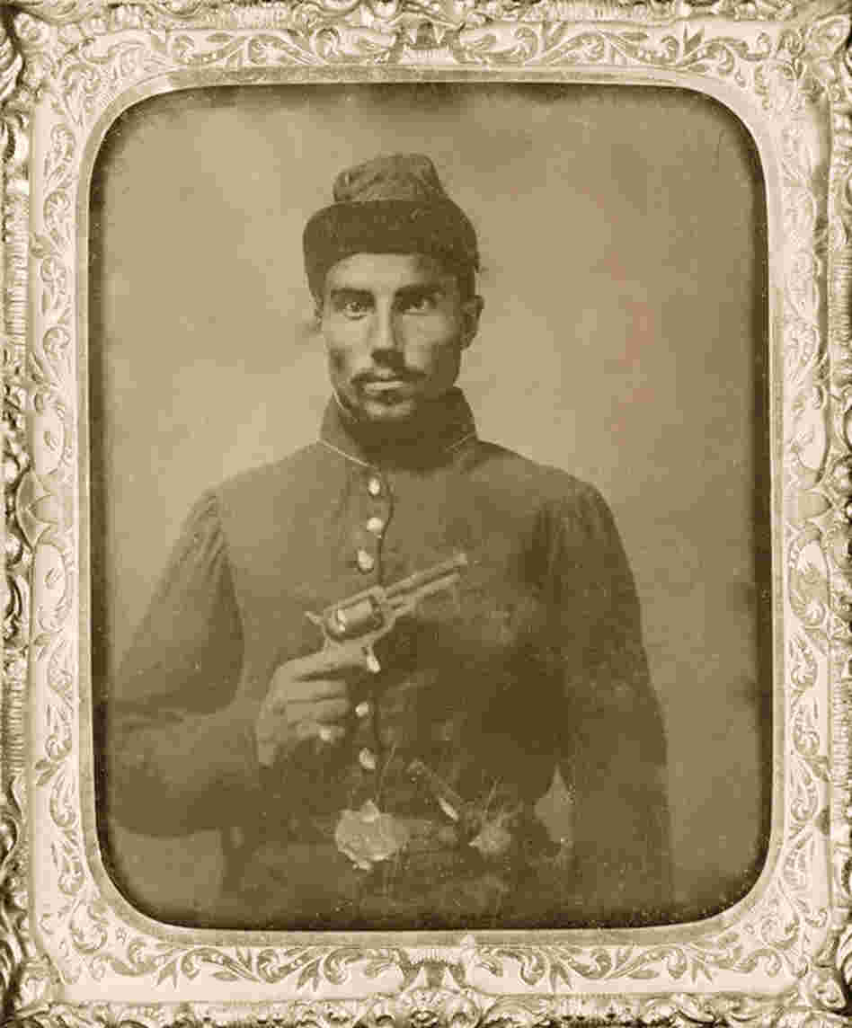 A black soldier poses with his revolver in 1865. 