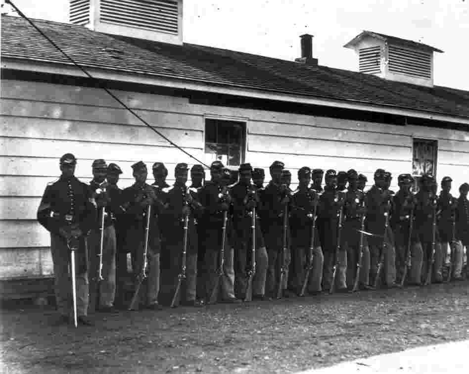 By 1865, when this photograph was taken, African-Americans were signing up in record numbers, prompted in part by 1863's Second Battle of Fort Wagner. In that battle, a black infantry regiment, the 54th Massachusetts, fought in an unsuccessful assault on a Confederate bastion. The heroism of the unit became national news, and convinced the Union to begin recruiting black soldiers in greater num...