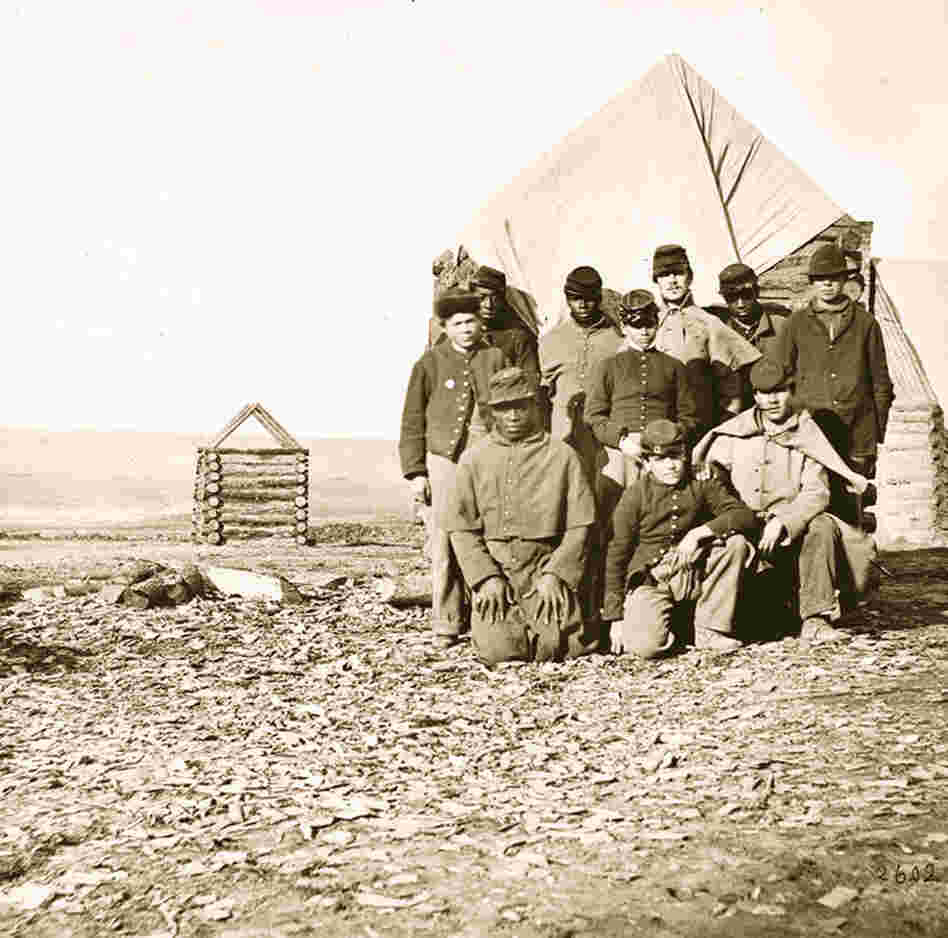 Black and white Union soldiers pose together in 1863. 