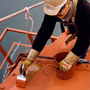A painter touches up one of the bridge's cables. When it came time to decide the paint color for the bridge, consulting architect Irving Morrow wanted a warm hue to contrast with the cool grays, blues and greens of San Francisco Bay.