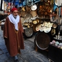A Tunisian man walks through a medina in February. Today, the shops are suffering for lack of tourists. "The tourism is catastrophic in Tunis today," says Said Ayari, who sells handicrafts like traditional pointed leather shoes.