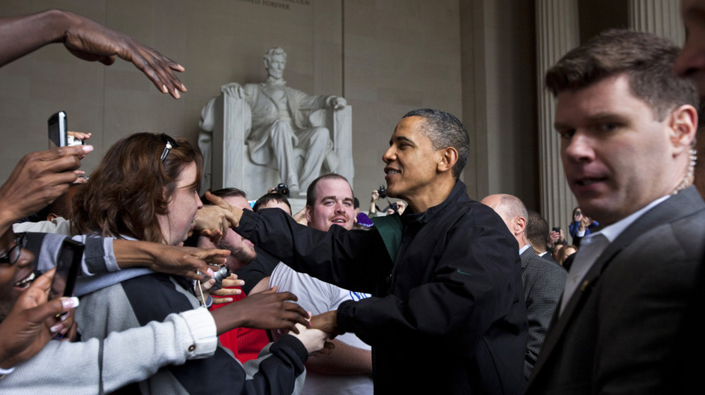 Barack Obama shakes hands with tourists visiting the Lincoln Memorial in Washington, D.C., Saturday during a surprise visit a day after budget negotiations with Congress prevented a government shutdown.