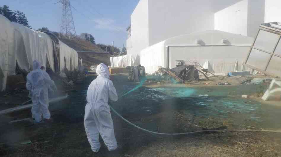 Workers at the Fukushima Dai-ichi nuclear power plant spray a substance to help reduce dust on April 1. The cleanup operation at the facility could take more than a decade. Workers at the Fukushima Dai-ichi nuclear power plant spray a substance to help reduce dust on April 1. The cleanup operation at the facility could take more than a decade.