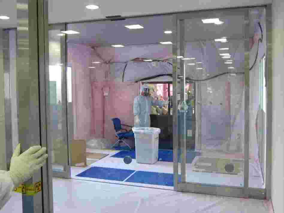 A radiation decontamination area was built into the entrance of a building at the Fukushima Dai-ichi power plant. Damage to the facilities and the reactor buildings is slowing efforts to stabilize the nuclear crisis.