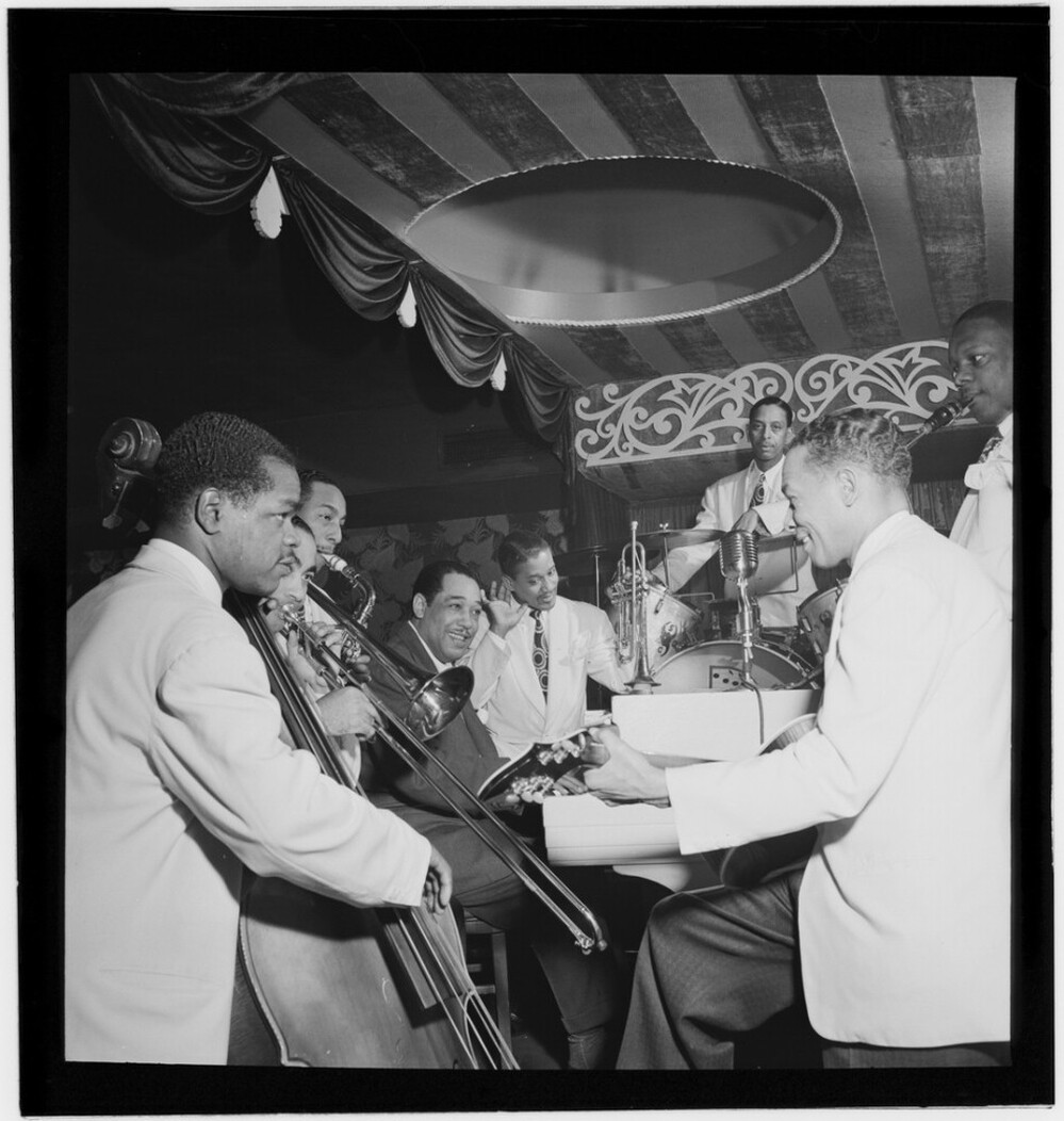 Duke Ellington (left of center) poses with some of his sidemen in 1946, including Junior Raglin, Lawrence Brown, Johnny Hodges, Ray Nance, Sonny Greer, Fred Guy and Harry Carney.