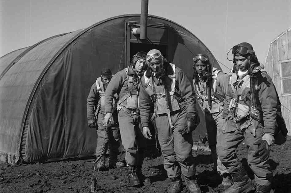 A group of Tuskegee Airmen exit the parachute room in Ramitelli. 