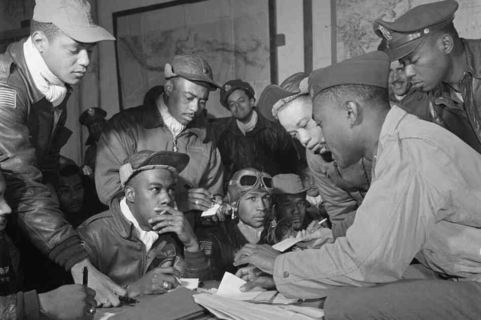Hiram Mann (third from left) was a member of the elite Red Tail pilots of the Tuskegee Airmen. Here, he's shown with his fellow airmen at Ramitelli Air Base in Italy in March 1945. That month, the Red Tails escorted Allied bombers from Ramitelli to Berlin, the longest mission in the European theater. 
