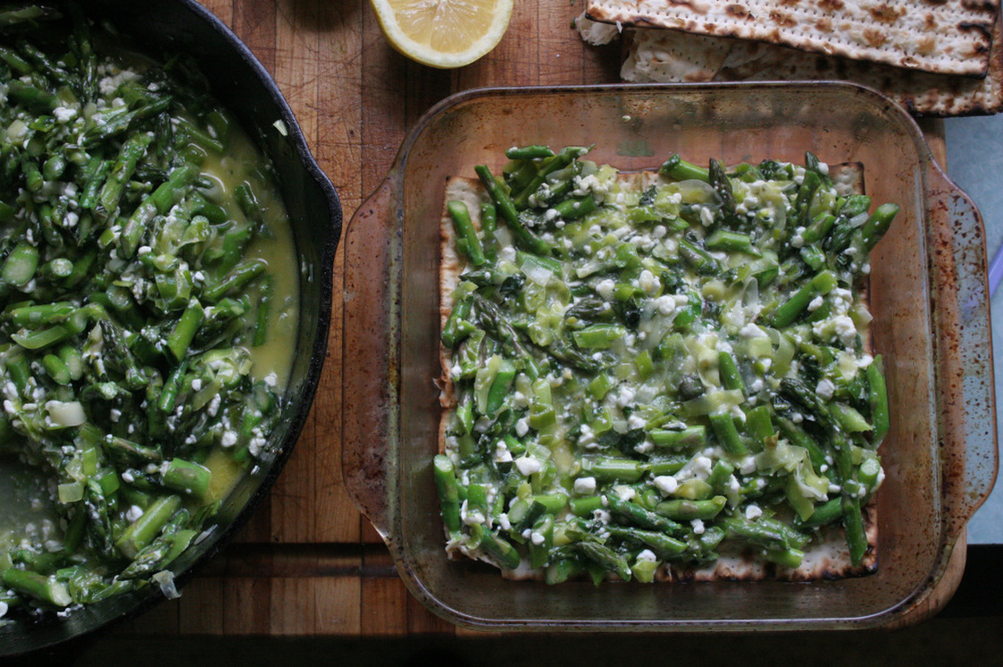 The prepared leek-and-asparagus filling is spread between layers of water-dampened matzo.