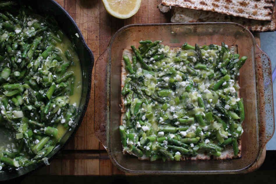 The prepared leek-and-asparagus filling is spread between layers of water-dampened matzo.