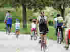 Family cycling on a path. Family cycling on a path.