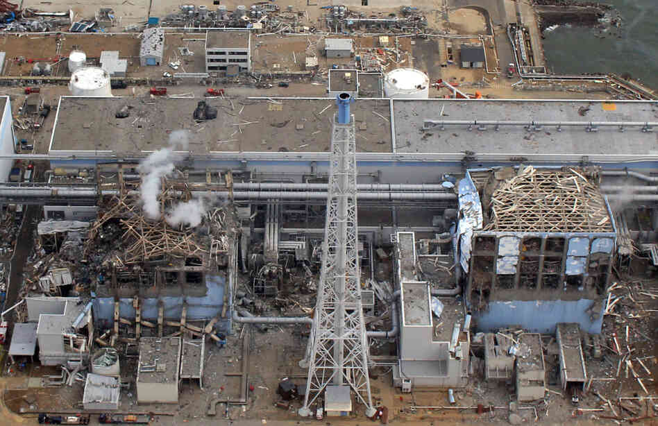 The Fukushima Dai-Ichi plant Reactor Numbers Three and Four on March 20, 2011. Smoke rises over Three.