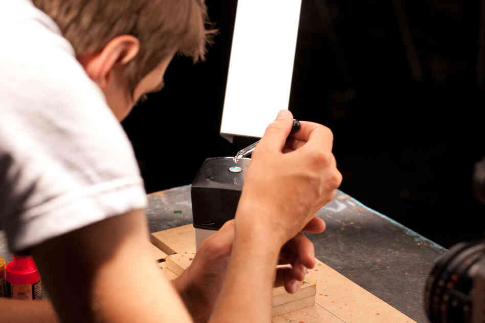 Small drops of colored paint are placed on a stretched black balloon. Small drops of colored paint are placed on a stretched black balloon.