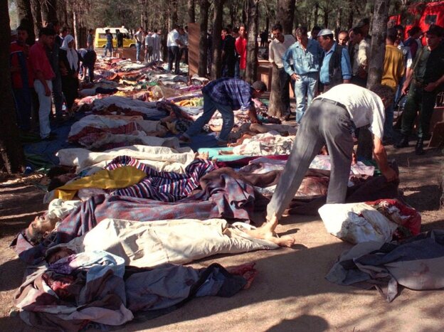People try to identify relatives after a massacre at Rais in the Sidi Moussa region of Algeria on Aug. 29, 1997.