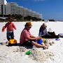 A family from New Orleans visits a beach in Pensacola, Fla., just before spring break season last month. In the distance, workers continue to clean up after the Deepwater Horizon oil spill. A family from New Orleans visits a beach in Pensacola, Fla., just before spring break season last month. In the distance, workers continue to clean up after the Deepwater Horizon oil spill.