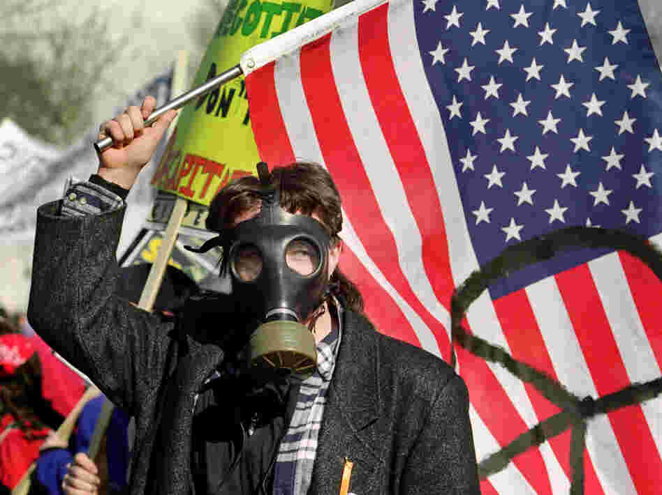 A demonstrator waves a flag marked with the peace symbol on Jan. 26, 1991, during an anti-Gulf War rally at the U.S. Capitol in Washington, D.C.