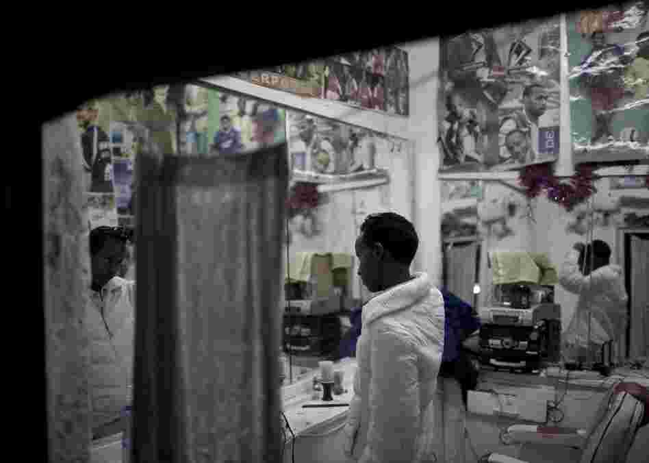 A young Somali checks himself out and fixes his hair in the mirrors of a small barbershop in Hargeisa.