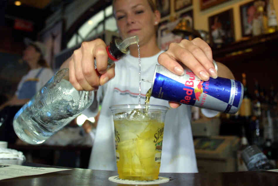 A bartender mixes a Red Bull energy drink with vodka in Key West, Fla. A can of Red Bull has more than double the caffeine of a can of coke. "It changes how you experience the drink," a psychologist says.
