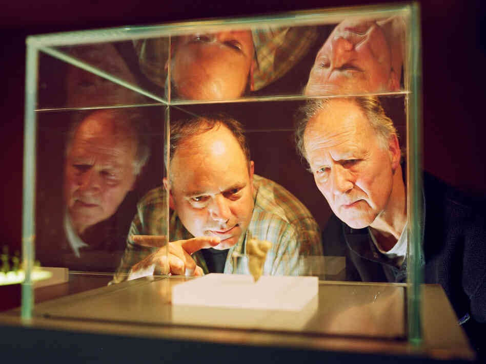 Anthropologist Nicholas Conard (left) and filmmaker Werner Herzog examine artifacts from the Chauvet caves in southern France.