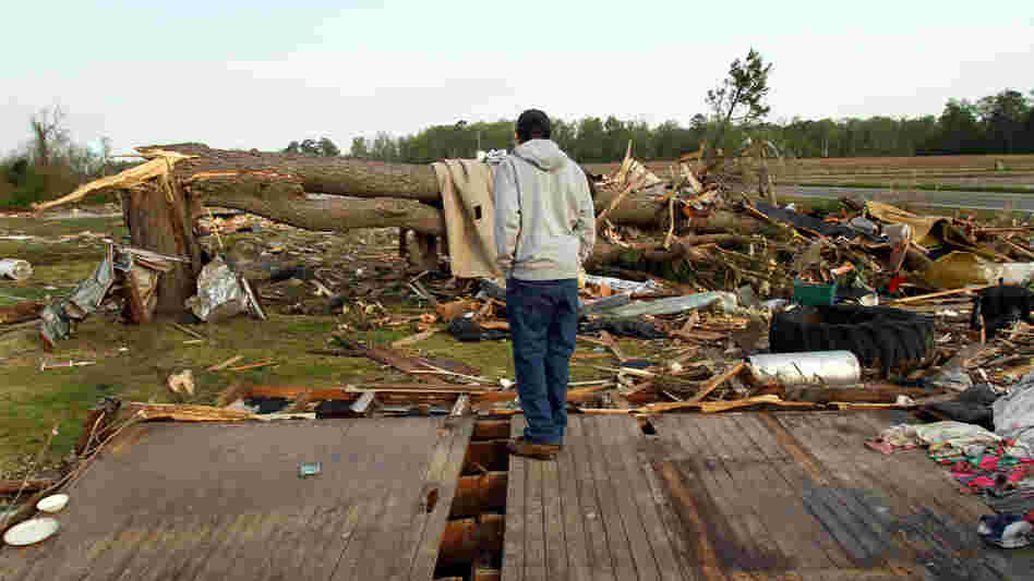 Clifton Perry stands on what's left of this home Monday in Colerain, N.C., where a tornado hit Saturday. Clifton Perry stands on what's left of this home Monday in Colerain, N.C., where a tornado hit Saturday.